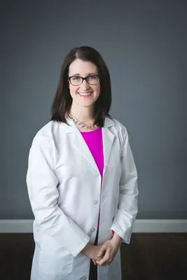 Female physician in lab coat professional headshot