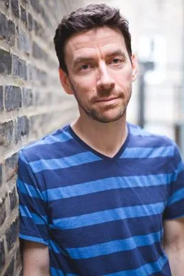Professional headshot with urban brick backdrop