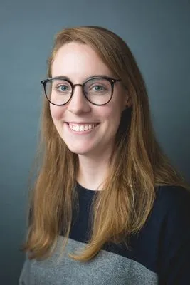 Teen headshot with teal backdrop