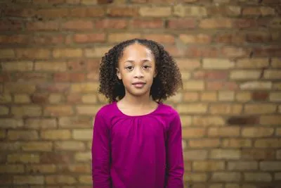 Child headshot with urban Chicago backdrop