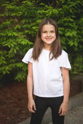 Child headshot outdoors in garden setting