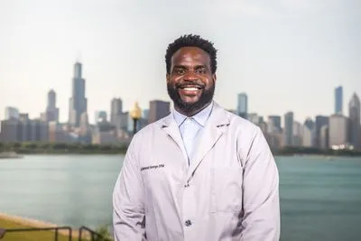 Doctor in lab coat with tie outdoor headshot