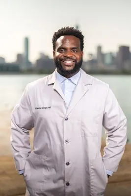 Physician in white lab coat on location