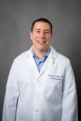 Male physician in lab coat professional portrait