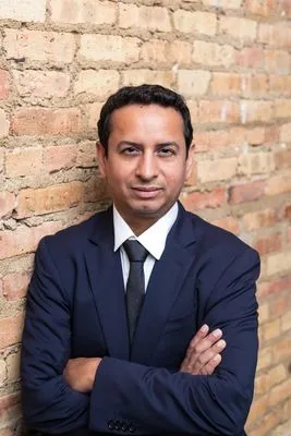 Formal on-location headshot in urban setting